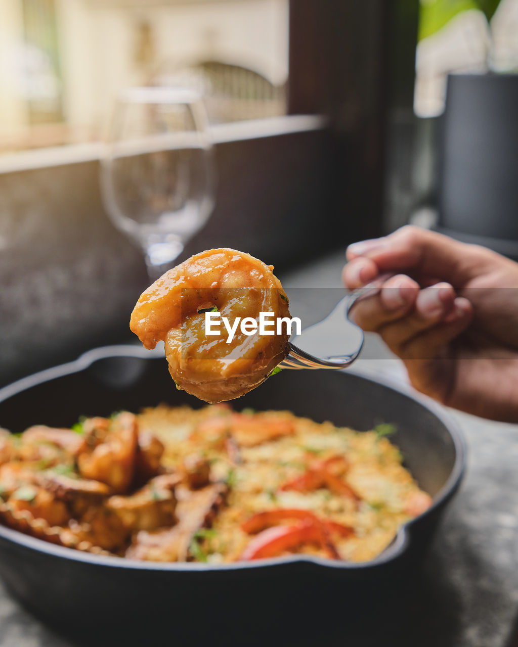 Woman enjoy peruvian food rice with seafood. arroz con mariscos, food served in pan, selective focus