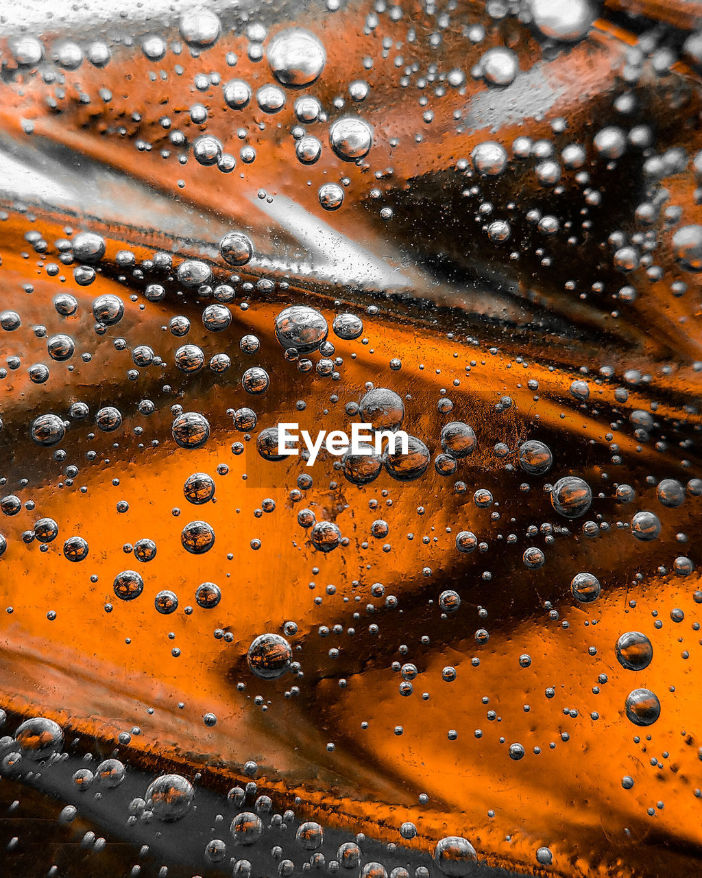 FULL FRAME SHOT OF WET GLASS WITH RAINDROPS