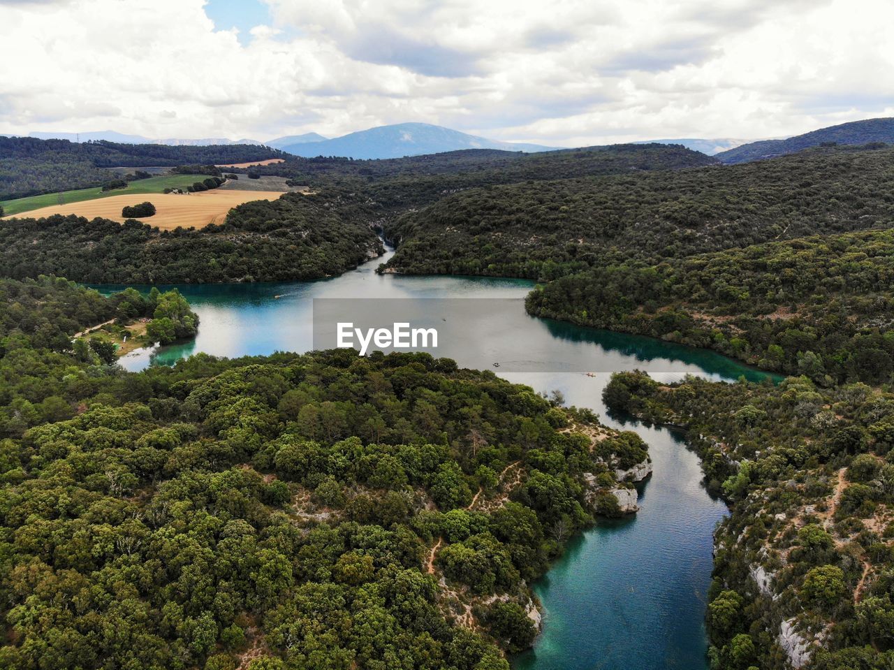 Scenic view of river amidst mountains against sky