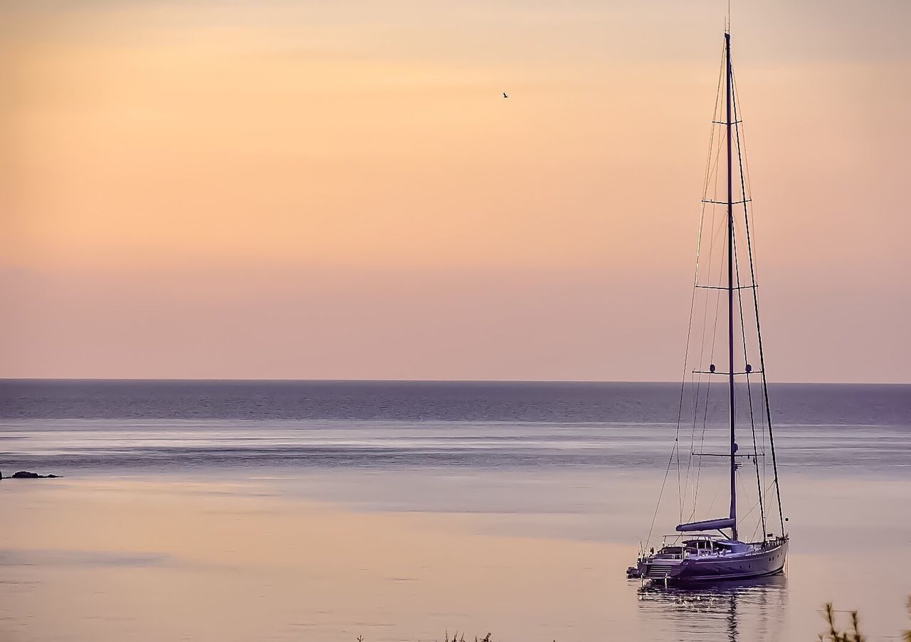 Sailboat in beach at sunset