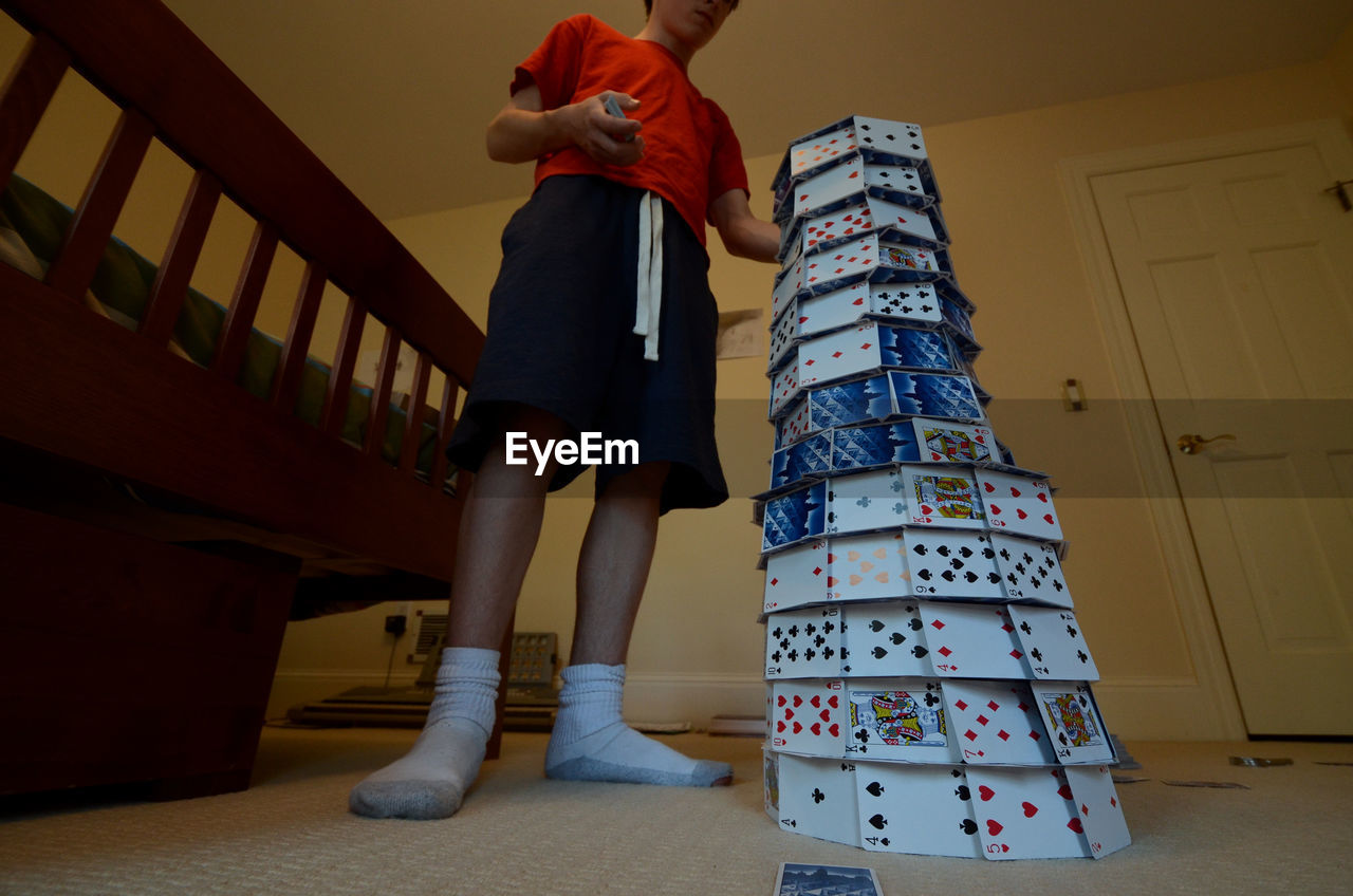 LOW SECTION OF CHILD STANDING ON FLOOR