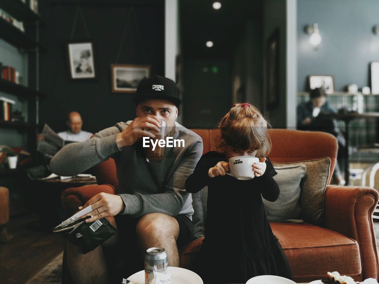 Father and daughter drinking coffee in cafe