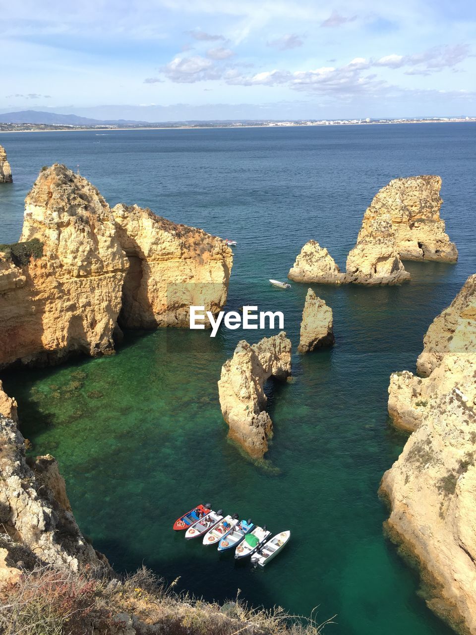 High angle view of rocks and sea against sky