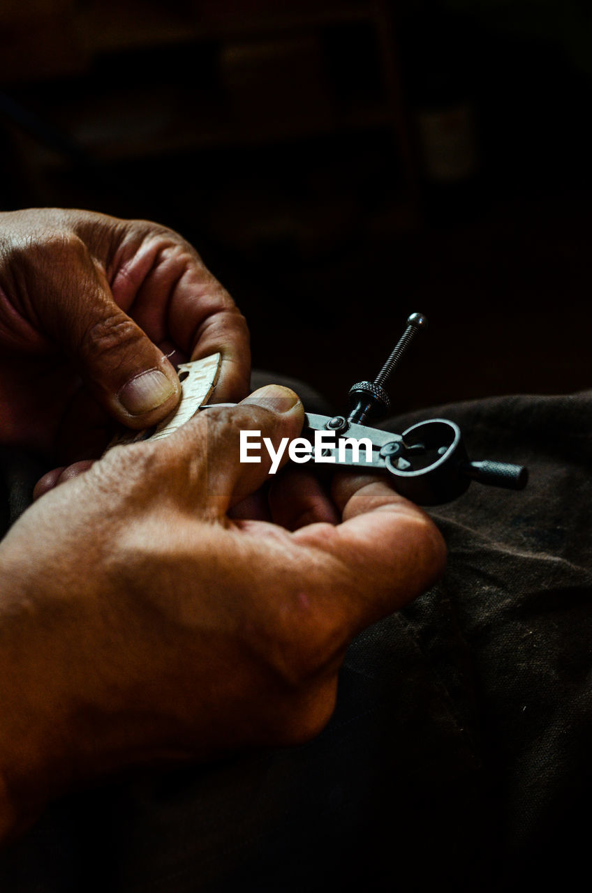 Violin maker luthier changing bridge of a handmade baroque violin