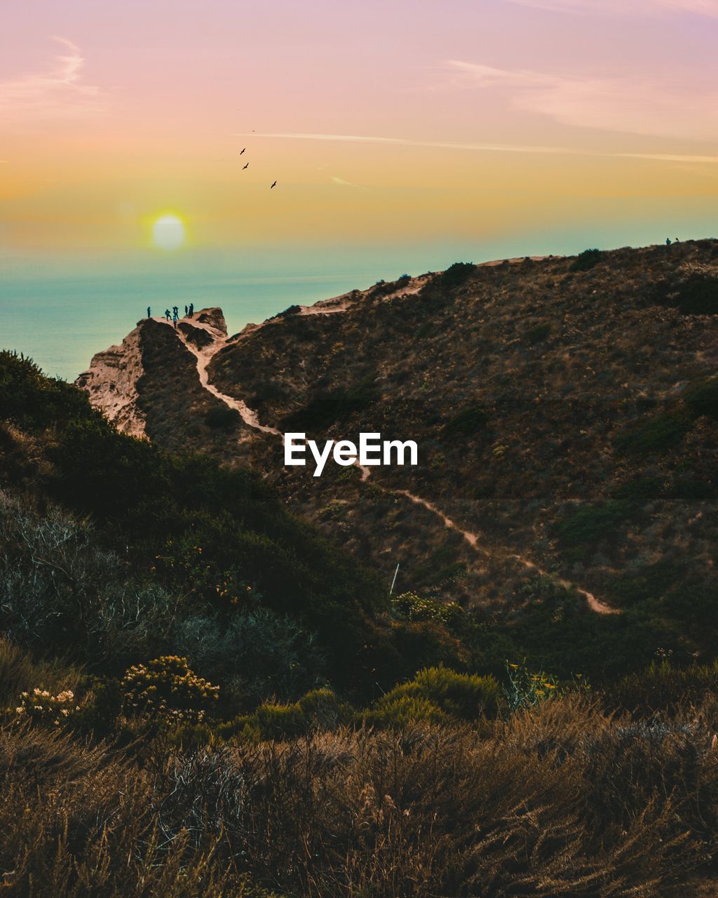 SCENIC VIEW OF MOUNTAIN AGAINST SKY DURING SUNSET