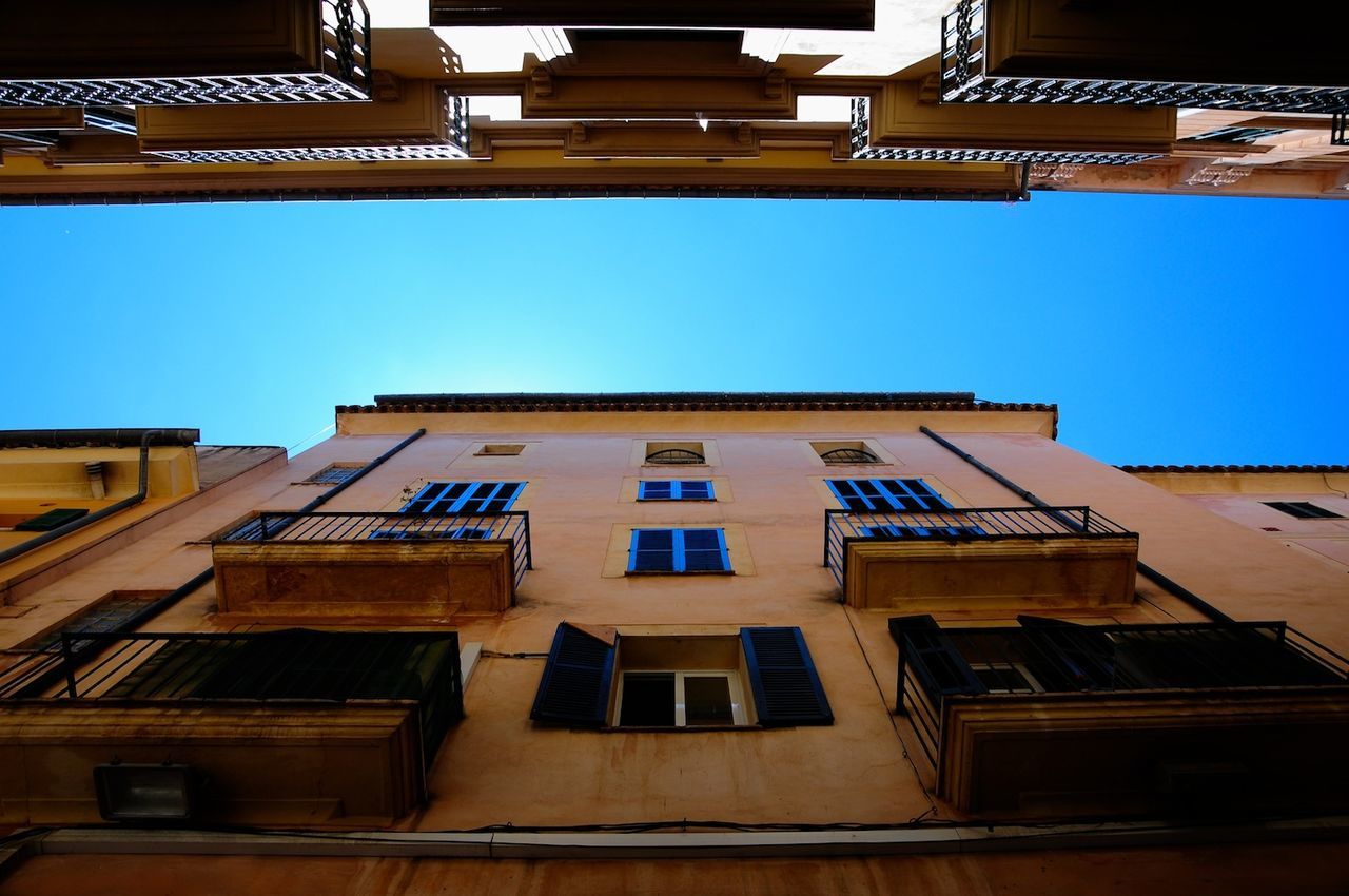 Low angle view of buildings against blue sky