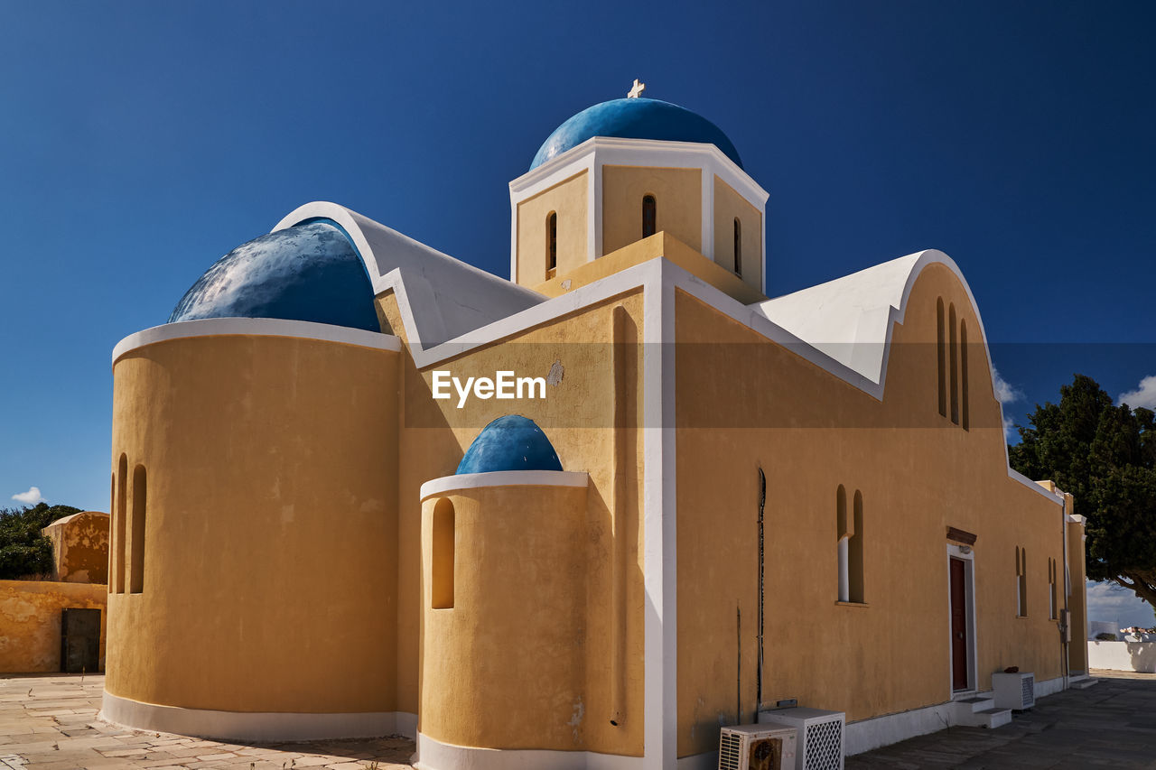 low angle view of church against clear blue sky