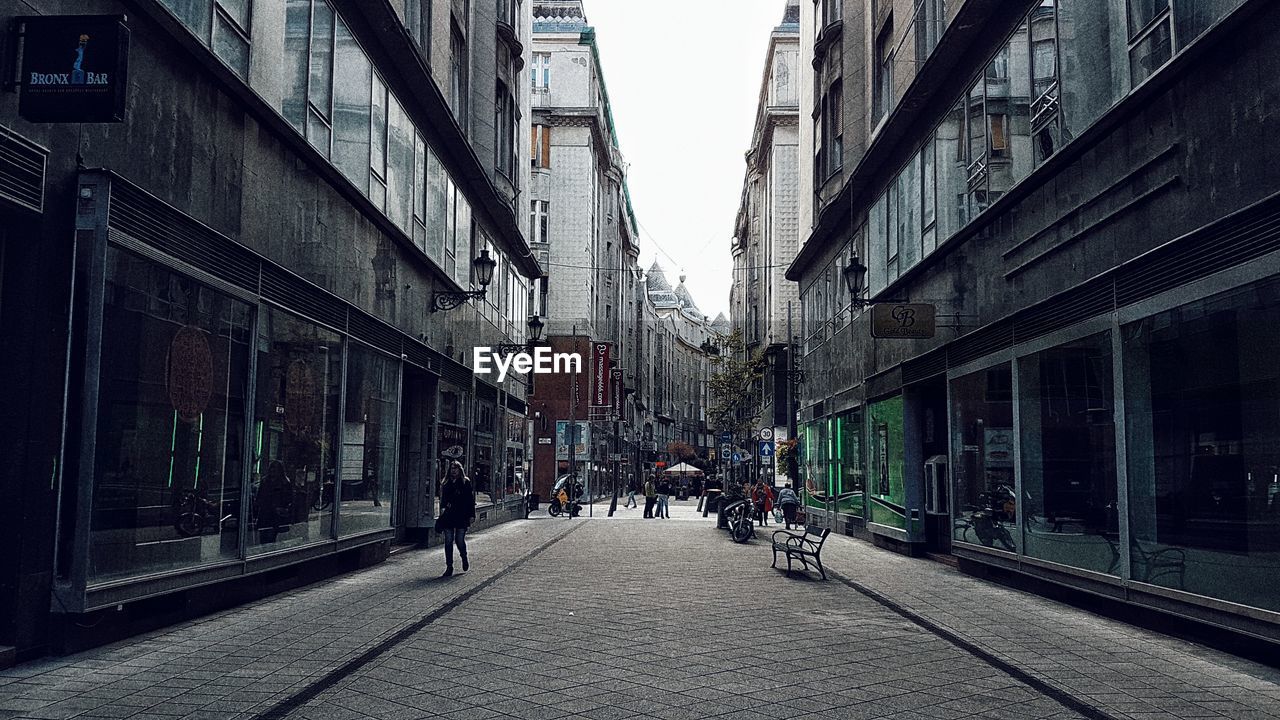 PEOPLE WALKING ON STREET IN CITY