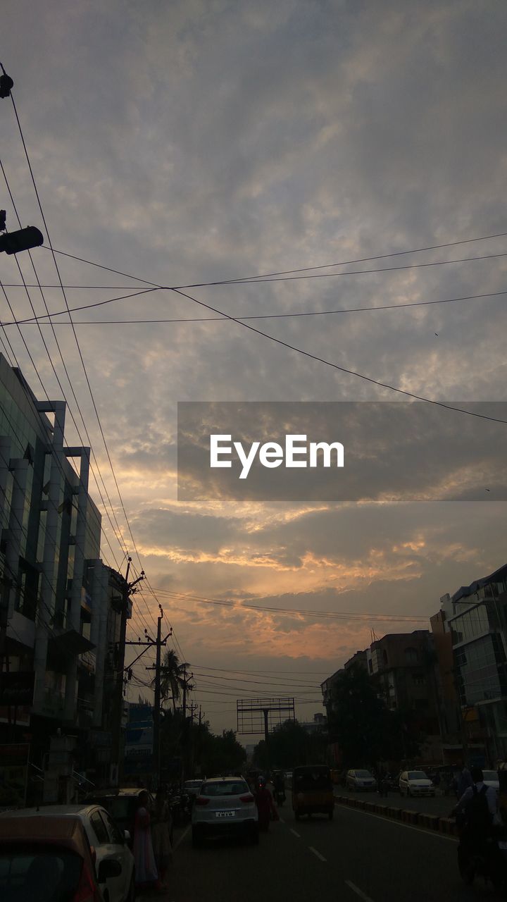 CARS IN CITY AGAINST SKY DURING SUNSET