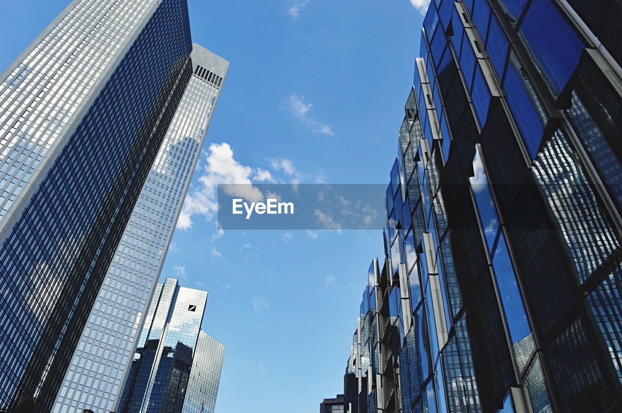 Low angle view of modern buildings in city against sky