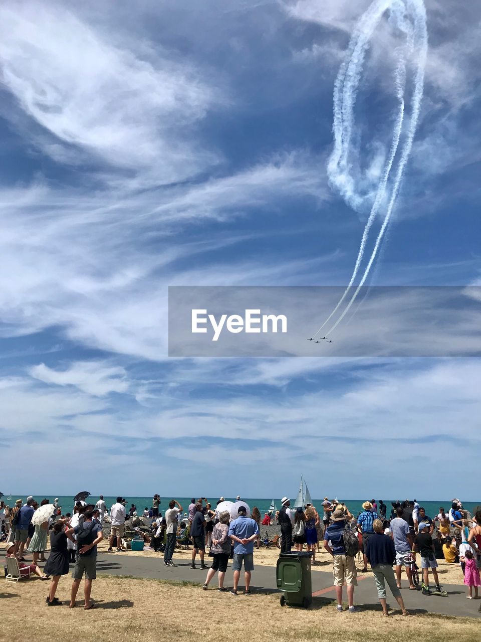 Crowd looking at airshow on beach