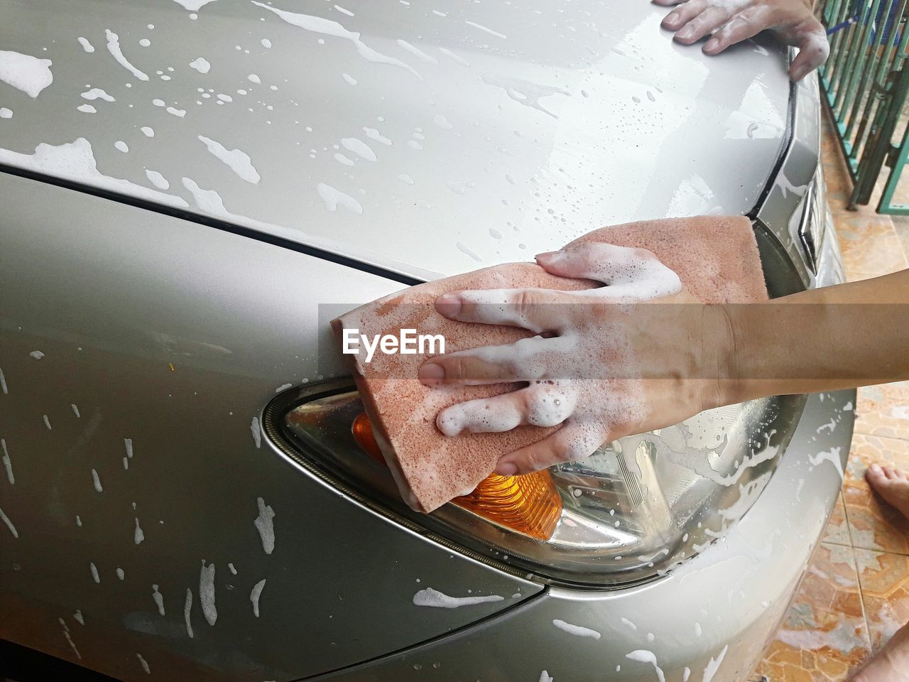 Cropped hands cleaning car