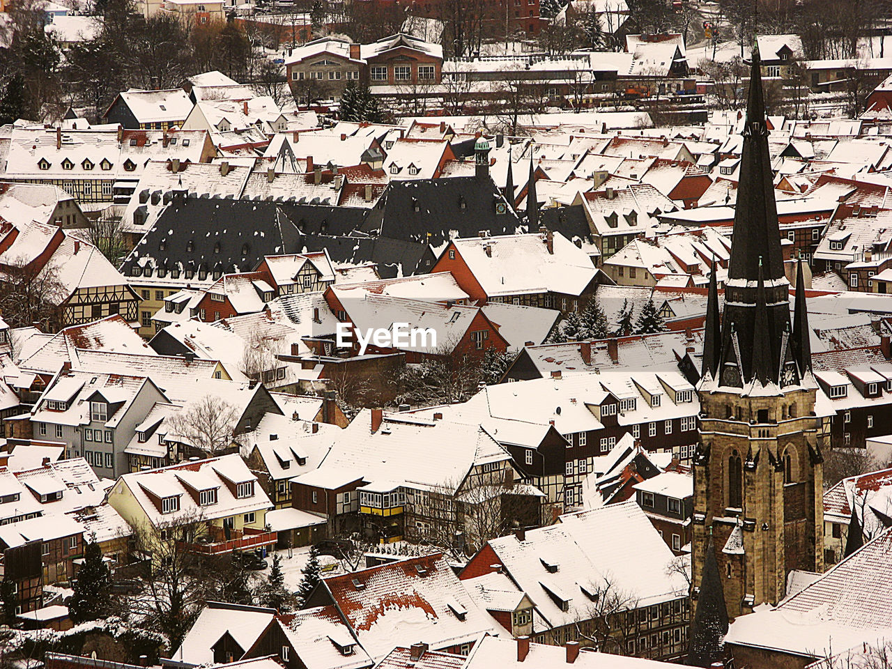 Snow covered rooftops and church building