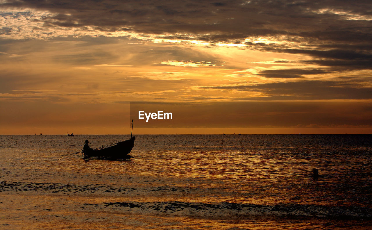 Silhouette sailboat on sea against sky during sunset