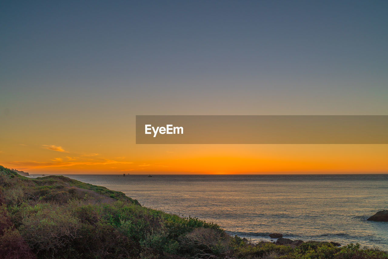 Scenic view of sea against sky during sunset