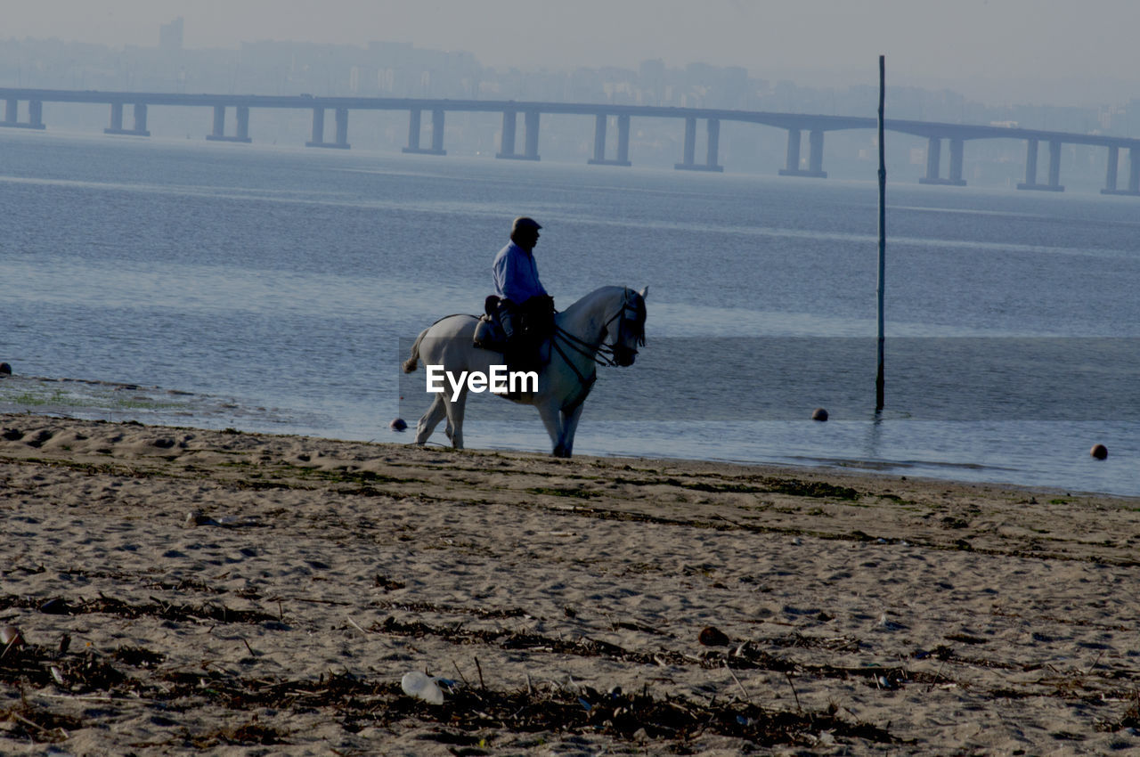 WOMAN STANDING ON SHORE