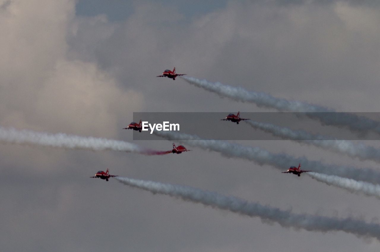 Low angle view of airshow against sky