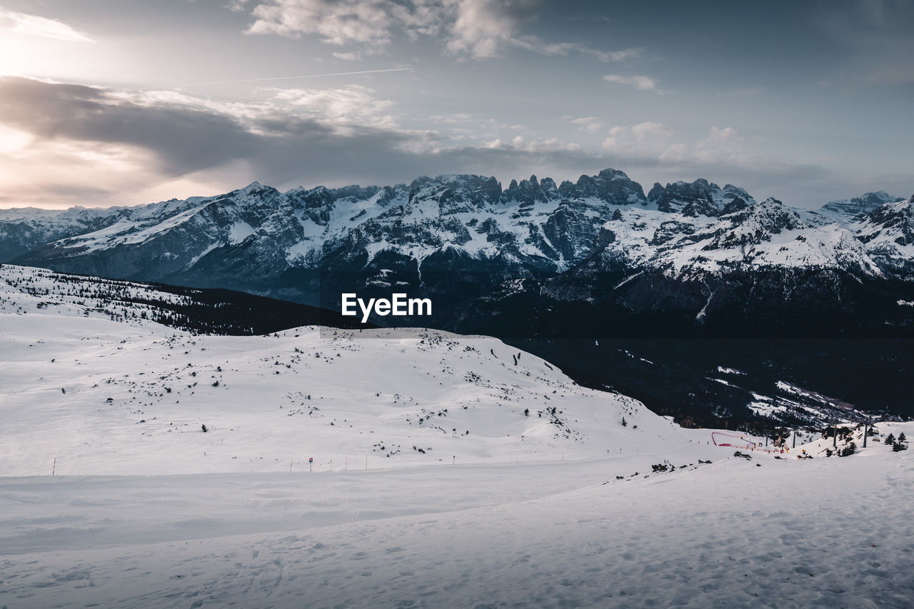 Scenic view of snow covered mountains against sky