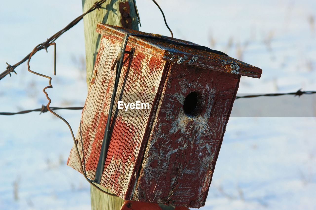 Close-up of a wooden bird house against sky