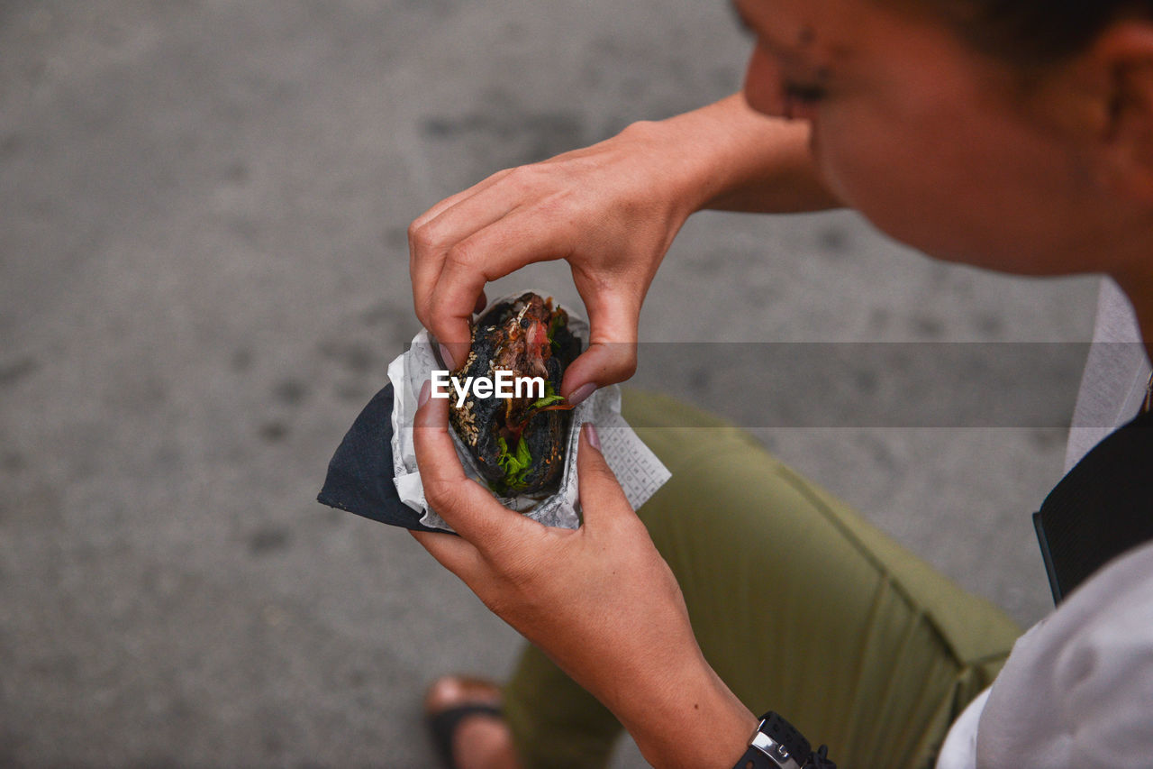 Person holding food on street