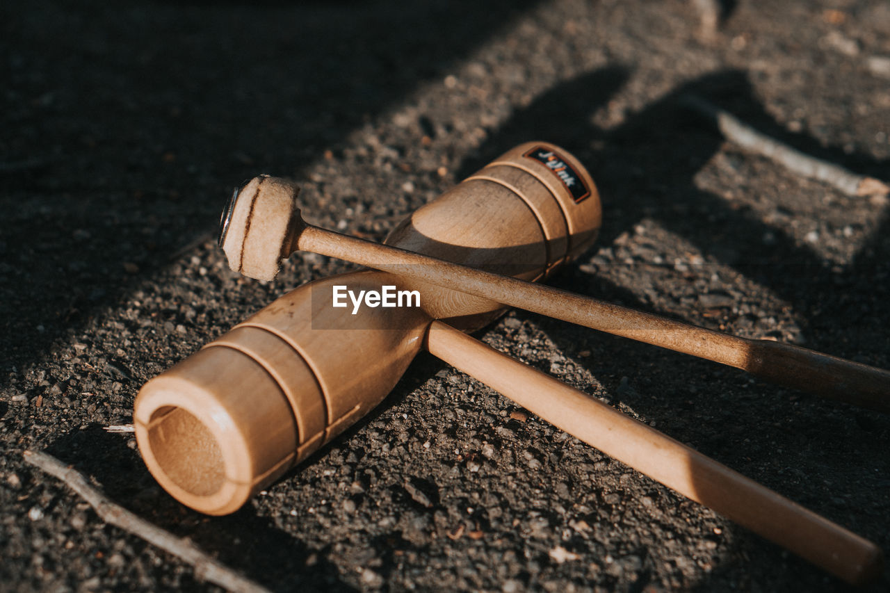 HIGH ANGLE VIEW OF TOOLS ON TABLE OUTDOORS