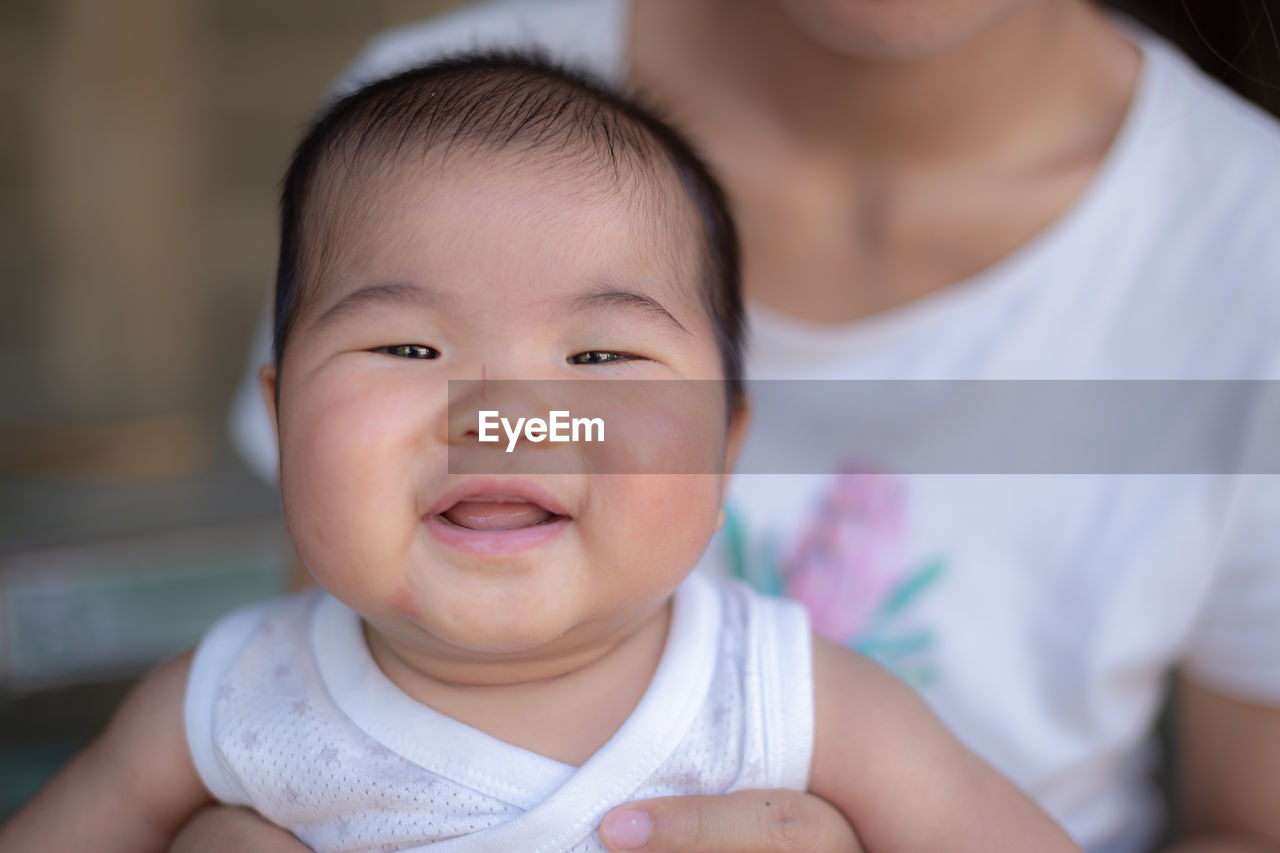 PORTRAIT OF CUTE BABY AT HOME