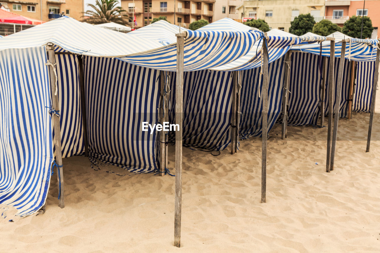 EMPTY CHAIRS AND TABLES AT BEACH