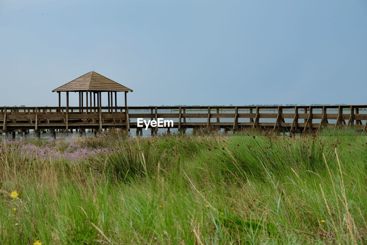 GAZEBO ON FIELD AGAINST CLEAR SKY