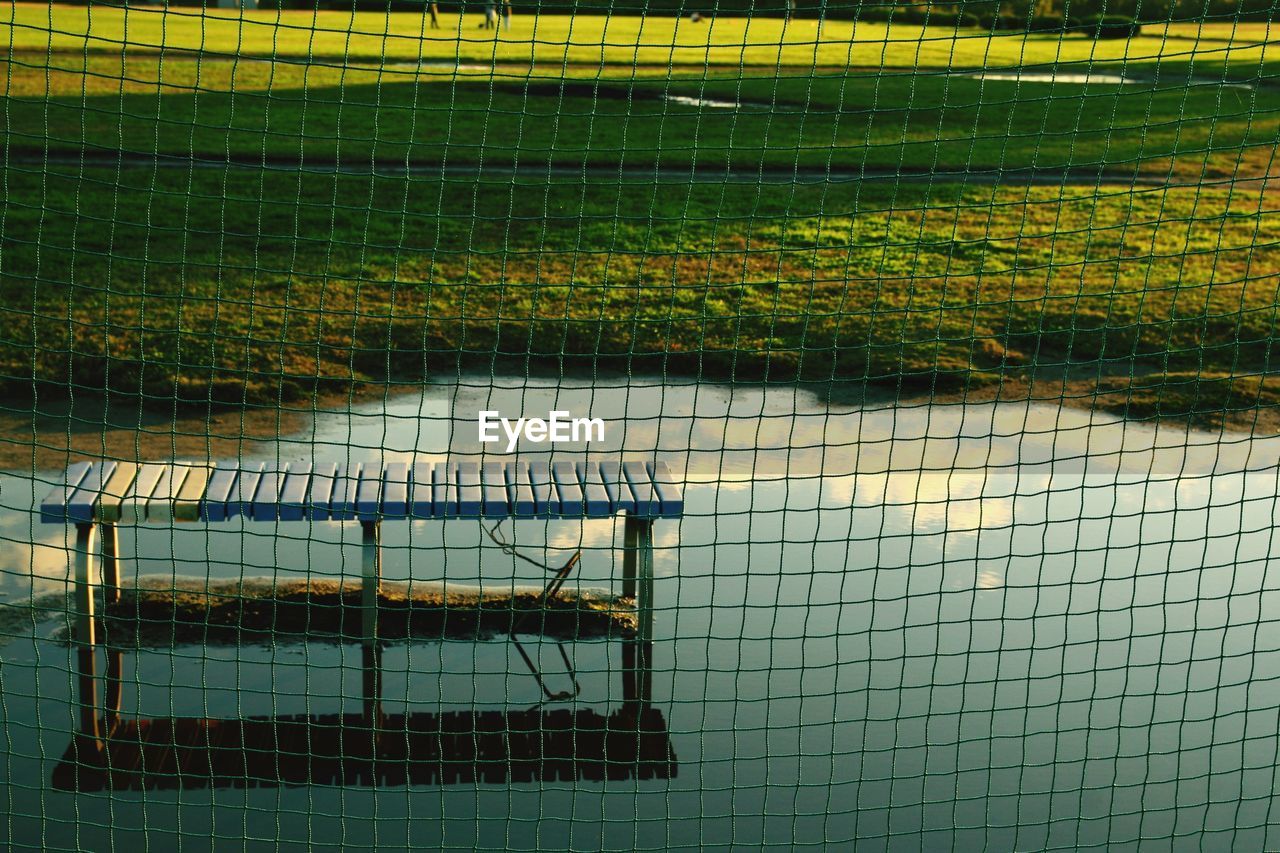 HIGH ANGLE VIEW OF A FENCE ON THE GROUND