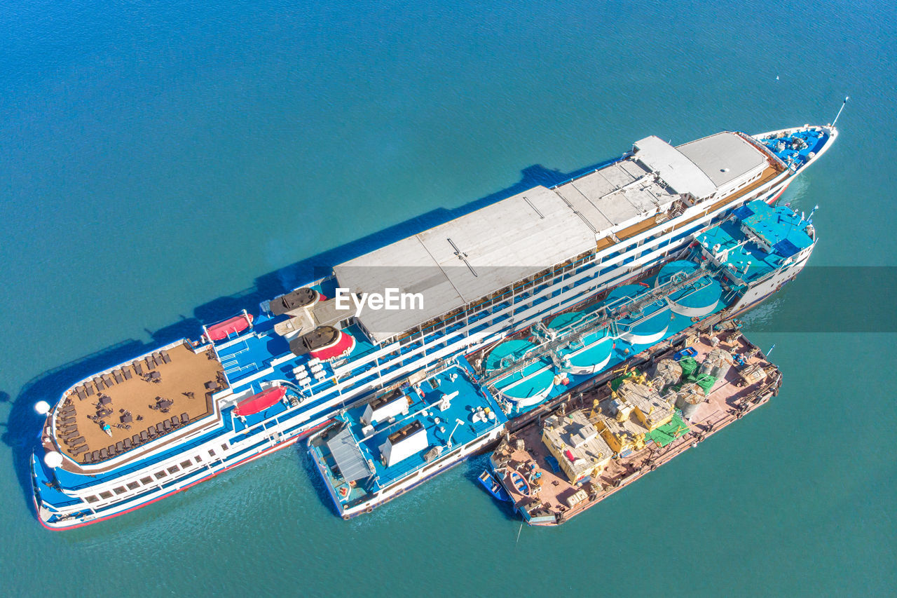 HIGH ANGLE VIEW OF SHIP MOORED AT SEA