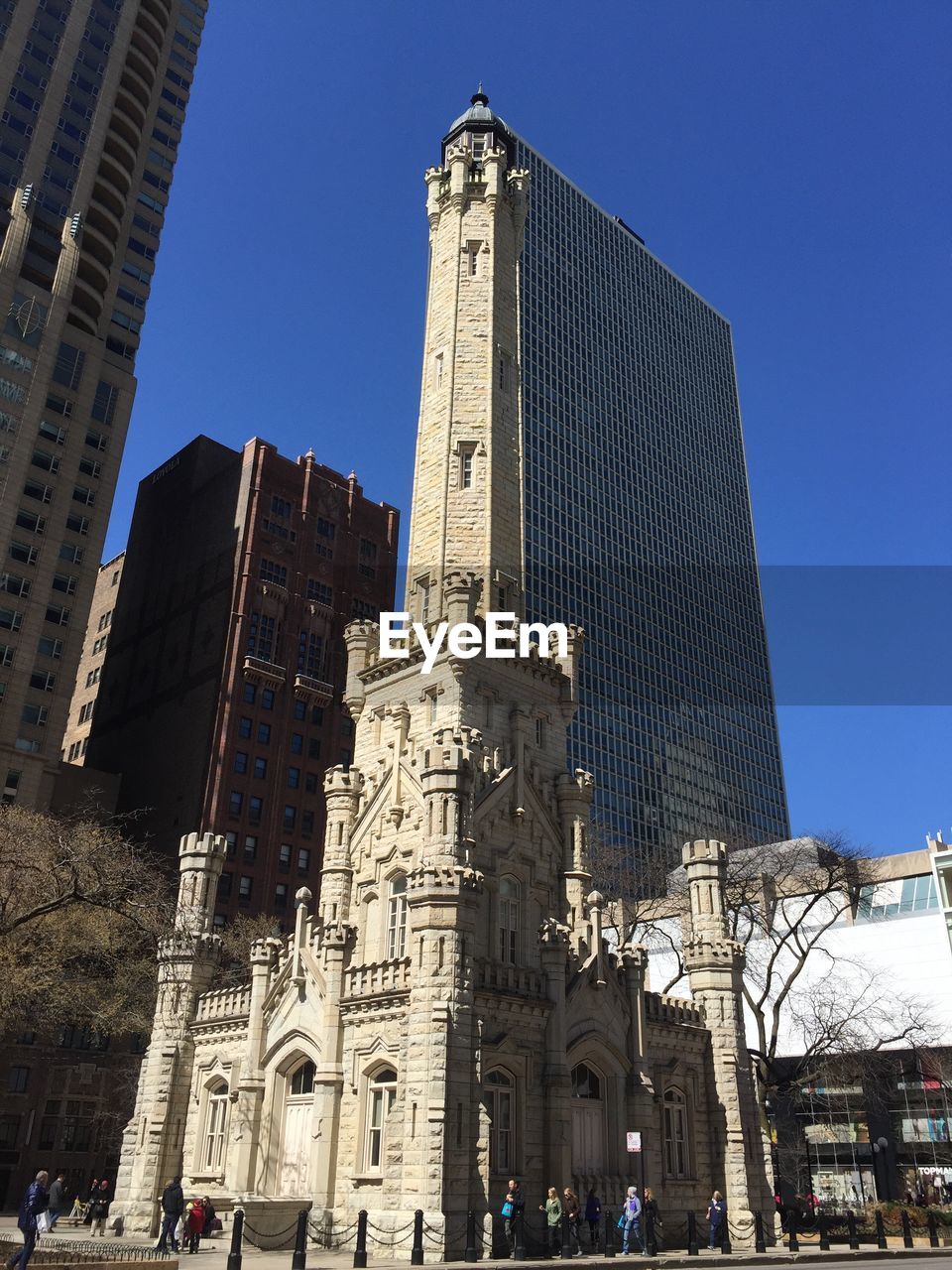 Low angle view of water tower place against clear blue sky in city