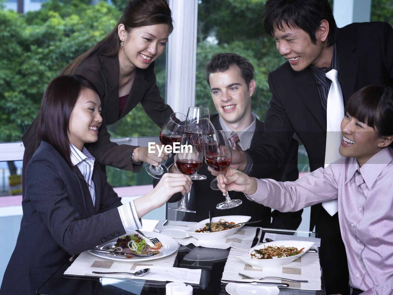 Colleagues with drinks at restaurant during meeting