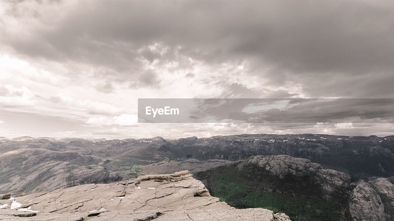 Scenic view of mountains against cloudy sky