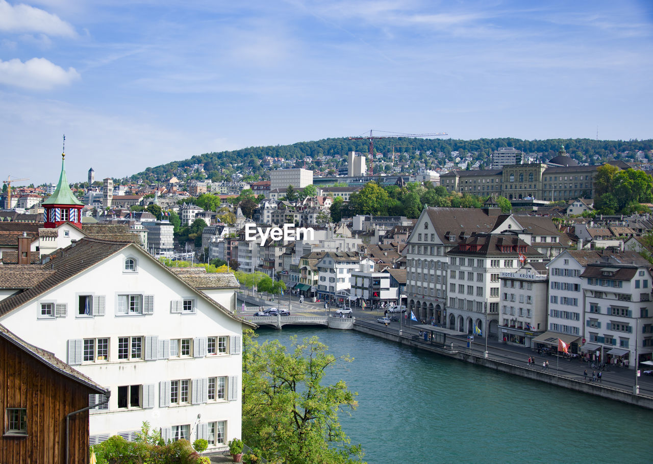 High angle view of river amidst buildings against sky