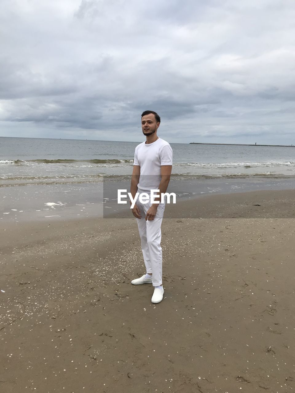 FULL LENGTH OF BOY STANDING ON BEACH