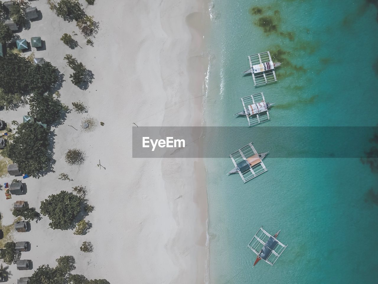 Directly above shot of outrigger canoes on shore at beach
