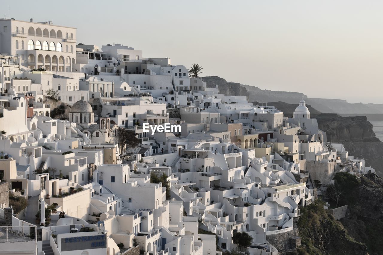 HIGH ANGLE VIEW OF BUILDINGS IN CITY AGAINST CLEAR SKY