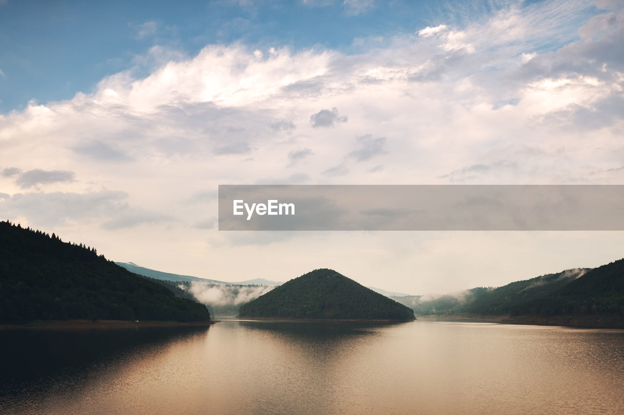 Scenic view of lake and mountains against sky