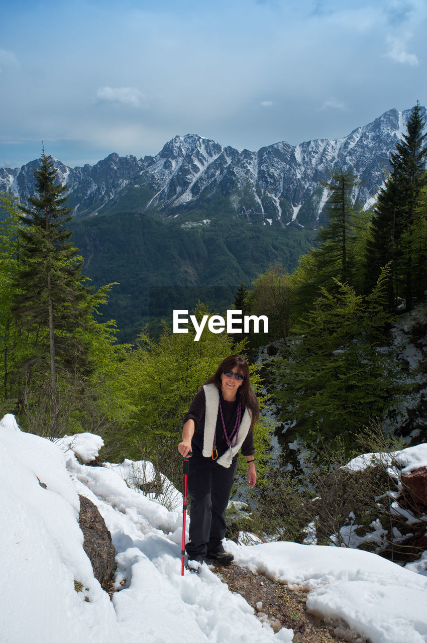Woman walking in a snowy trail in the mountains