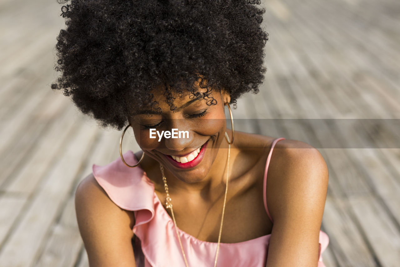 Young woman smiling on boardwalk