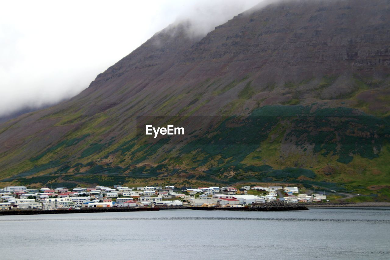 Scenic view of sea and mountains against sky