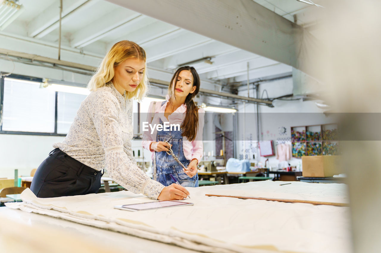 YOUNG WOMAN WORKING IN A MIRROR