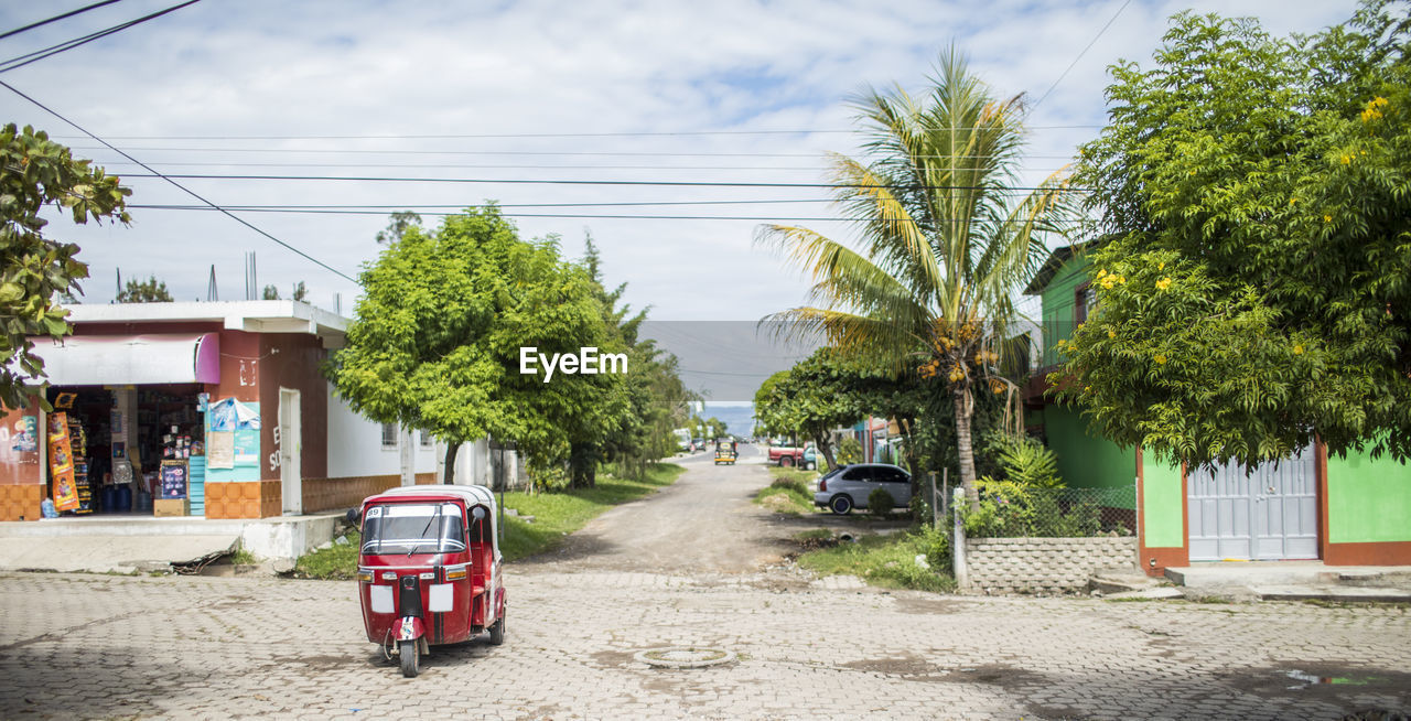 Tuk tuk driving on street in monjas, guatemala
