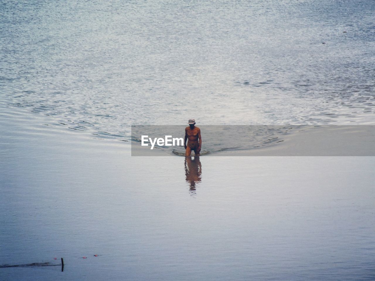 High angle view of man walking in sea