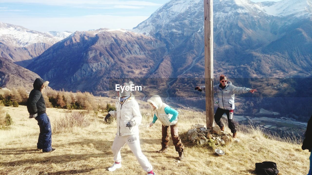 WOMAN STANDING ON MOUNTAIN