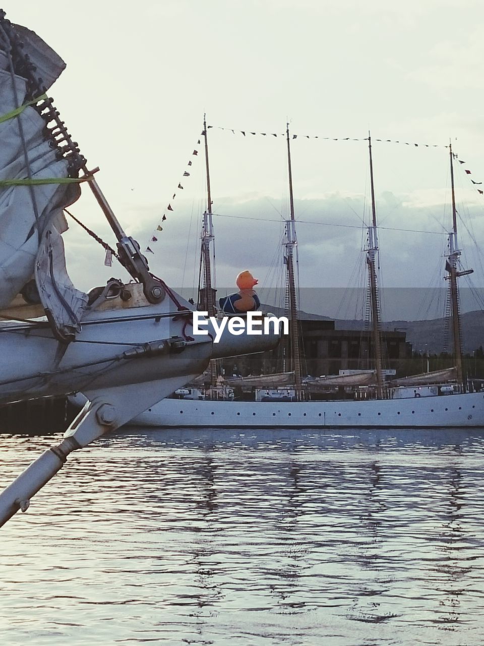 Toy on ship's bow on sea at dusk