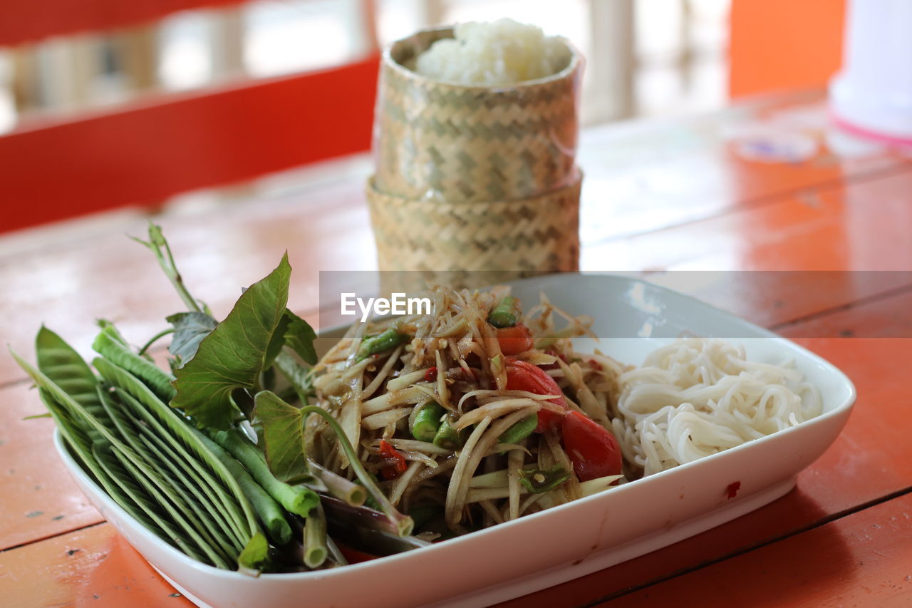 Close-up of papaya salad served on table