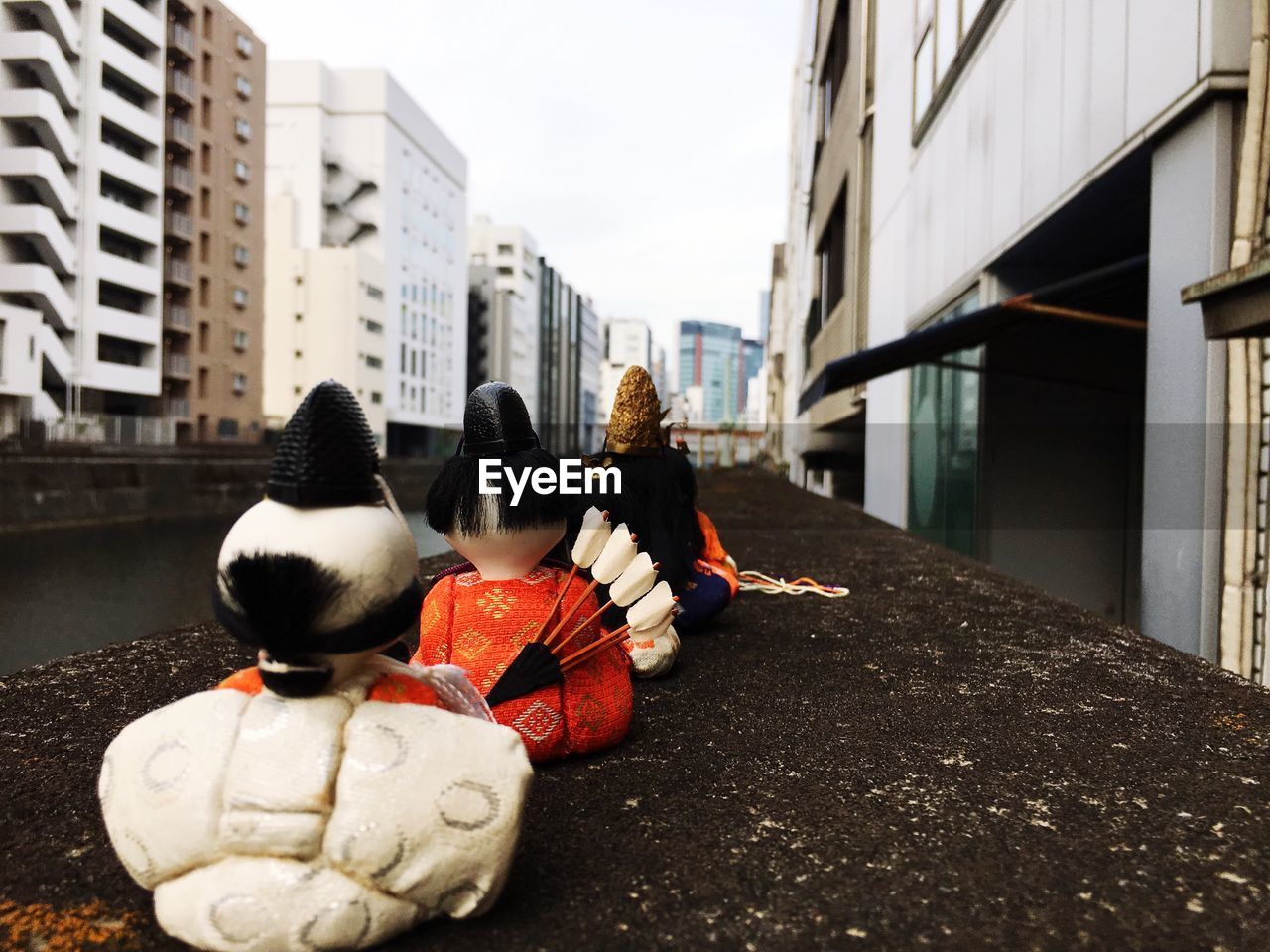 REAR VIEW OF TOYS ON STREET IN CITY
