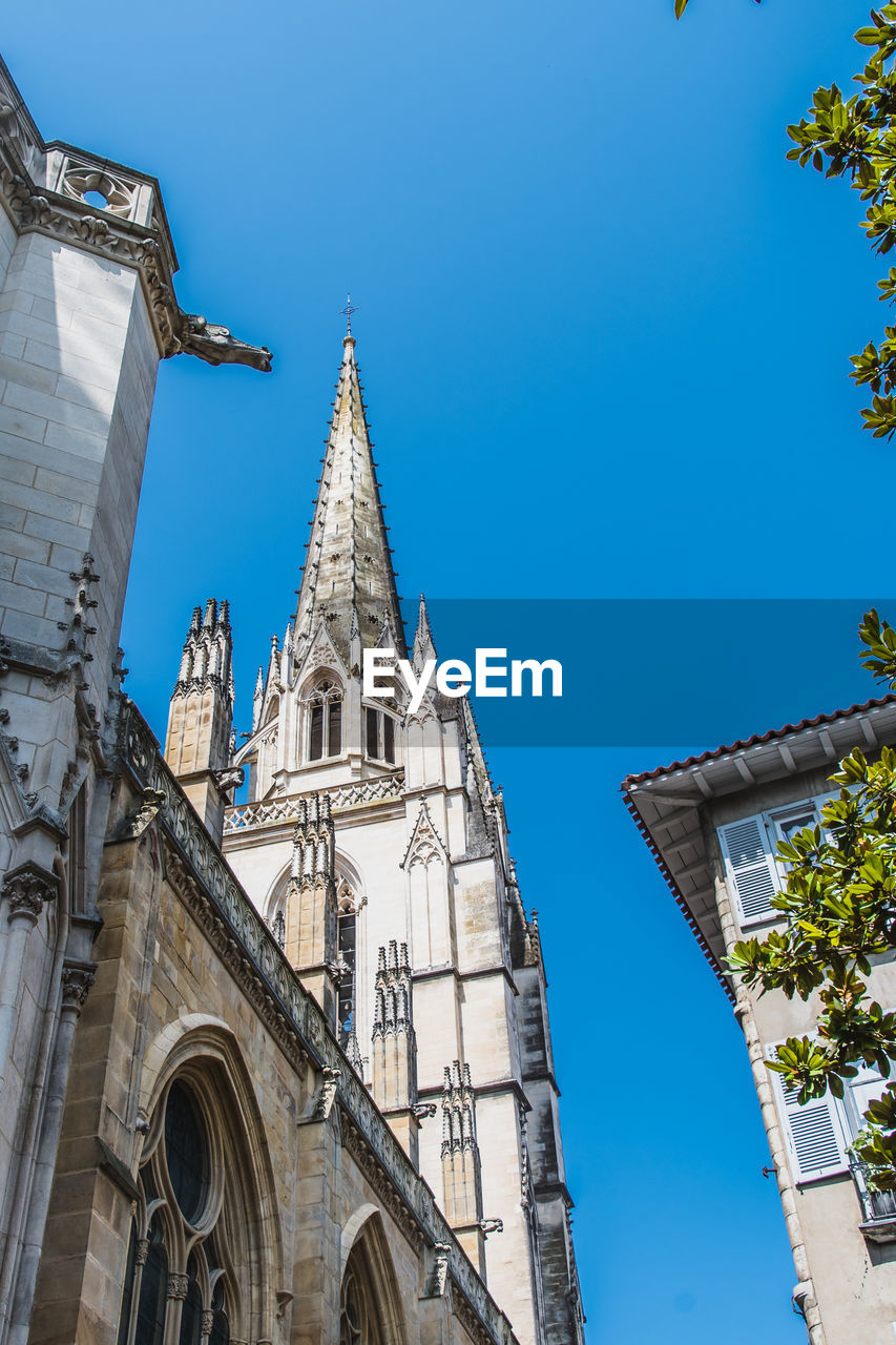 LOW ANGLE VIEW OF BUILDING AGAINST BLUE SKY