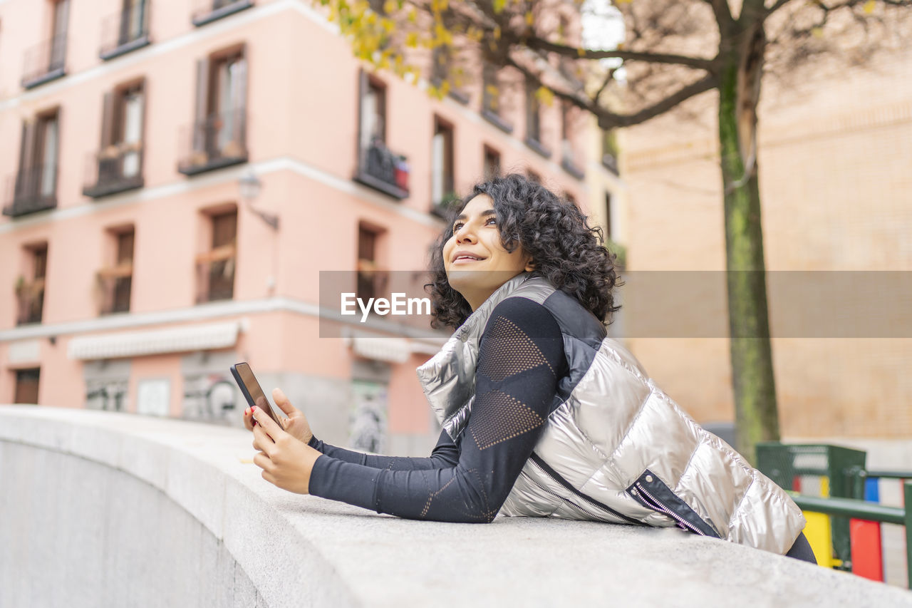 Woman enjoying the city and using her smartphone